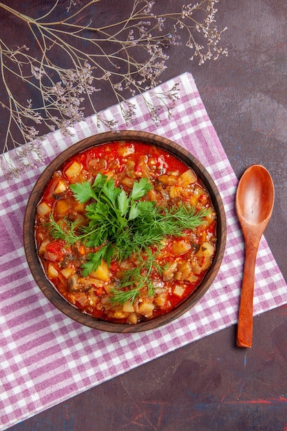 Top view tasty cooked vegetables sauce meal with greens on the dark surface sauce meal dish food