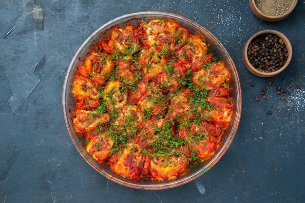 Top view tasty cooked vegetables with ground meat and greens inside pan on blue table dish meal meat cuisine food family taste