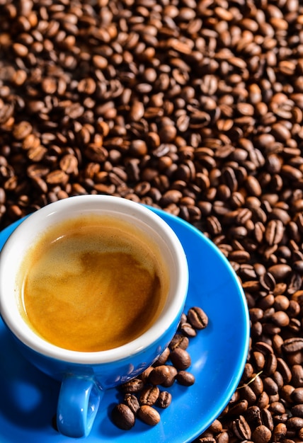 Top view of tasty cup of coffee on blurred background