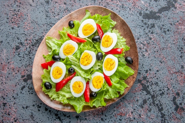 top view tasty egg salad with green salad and olives inside plate on light background