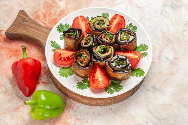 Top view tasty eggplant rolls with fresh tomatoes