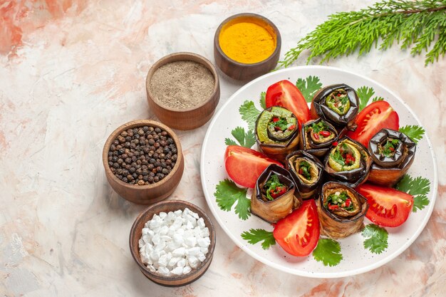 top-view-tasty-eggplant-rolls-with-greens-tomatoes-seasonings_140725-133875.jpg
