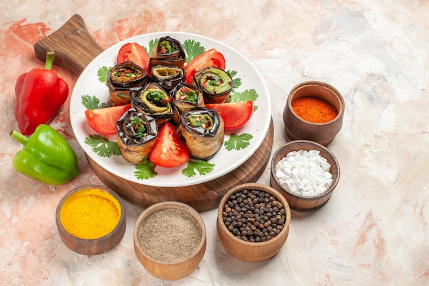 Top view tasty eggplant rolls with tomatoes and different seasonings