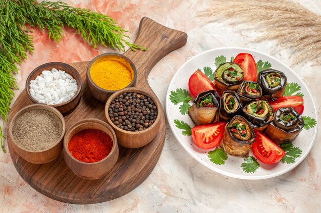 Top view tasty eggplant rolls with tomatoes and seasonings