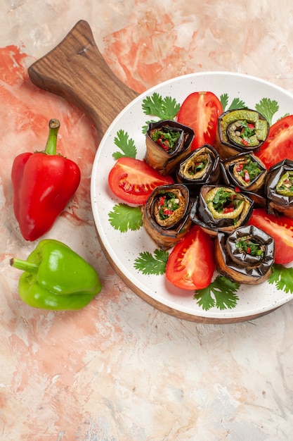 Top view tasty eggplant rolls with tomatoes