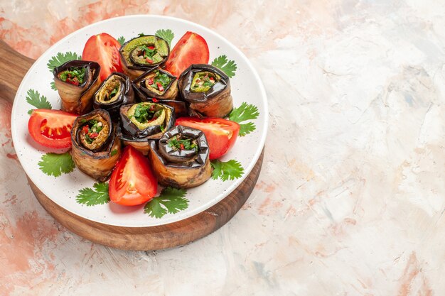 Top view tasty eggplant rolls with tomatoes