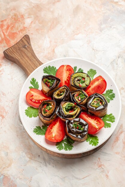 Top view tasty eggplant rolls with tomatoes