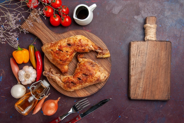 Бесплатное фото Вид сверху вкусной жареной курицы со свежими овощами и приправами на темном столе еда куриная еда овощное мясо