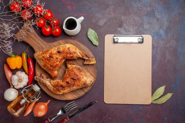 Free photo top view tasty fried chicken with fresh vegetables and seasonings on dark background food chicken meal vegetables meat