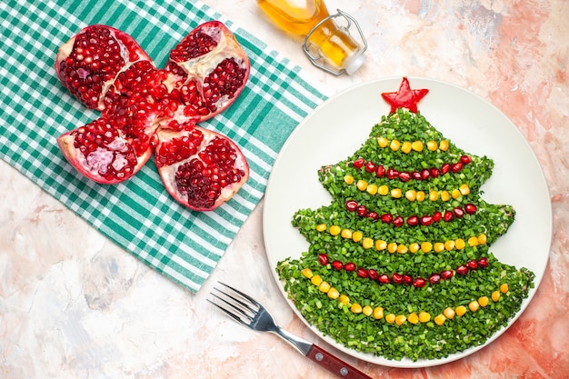 Top view tasty green salad in christmas tree shape on the light background