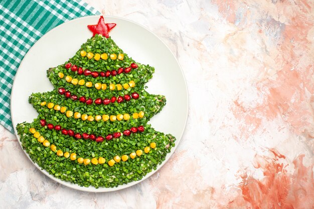 Top view tasty green salad in new year tree shape on light background