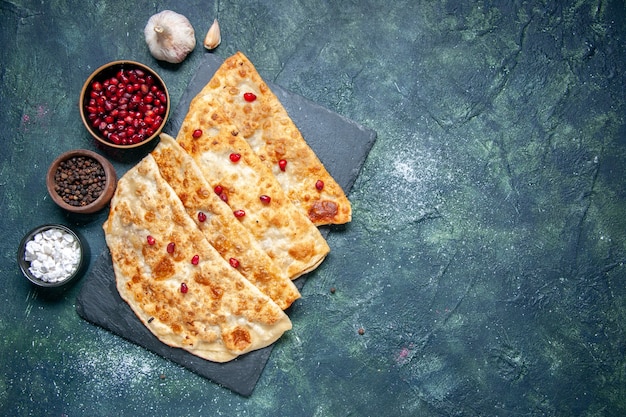 Top view tasty gutabs hotcakes with meat and pomegranates on dark background hotcake pastry color dough pie cake meal oven