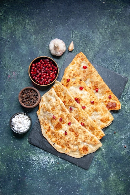 Top view tasty gutabs hotcakes with meat and pomegranates on a dark background hotcake pastry color oven dough pie cake meal