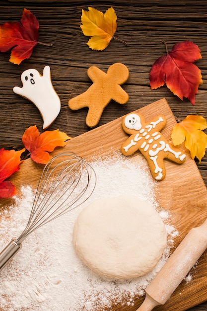 Top view tasty halloween cookies and dough