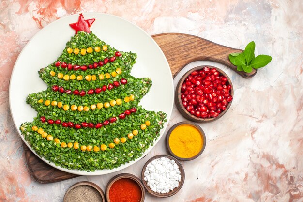 Top view tasty holiday salad in new year tree shape on light background