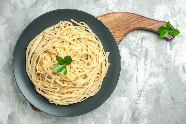 Top view tasty italian pasta on light background