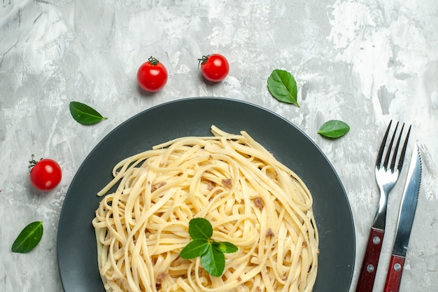 Top view tasty italian pasta with cutlery on the light background