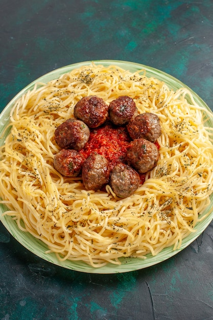 Top view tasty italian pasta with meatballs on the dark blue background