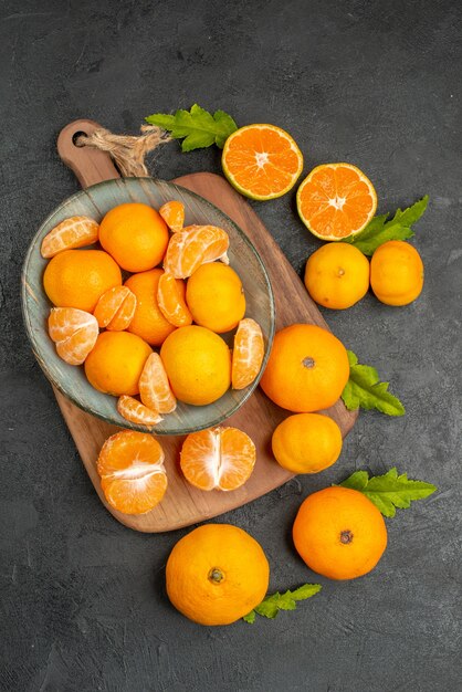 Top view tasty juicy tangerines inside plate on grey background