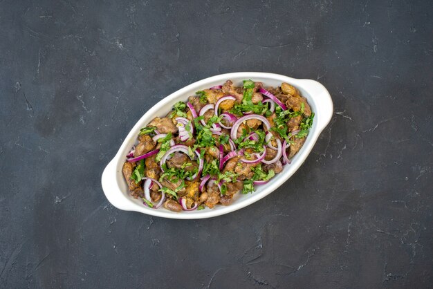 Top view of tasty kebab bowl on dark table free space