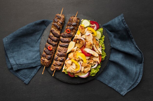 Top view of tasty kebab on slate with cloth