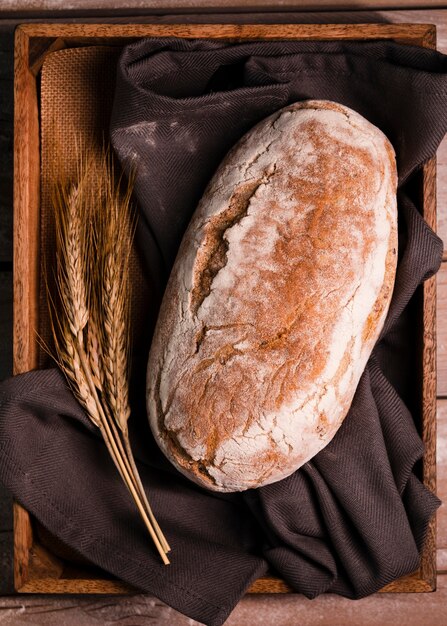 Free photo top view tasty loaf of bread with wheat