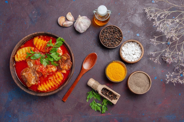 Top view tasty meat sauce with different seasonings on black