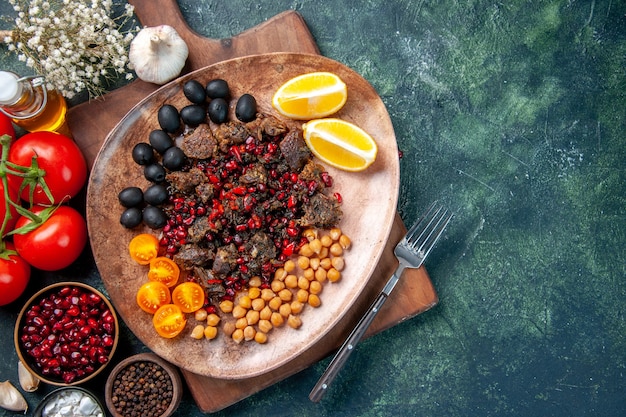 top view tasty meat slices fried meal with grapes and beans inside plate, dish food