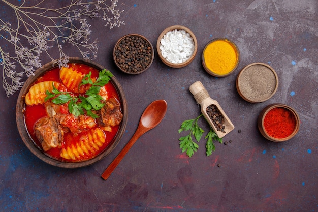 Free photo top view tasty meat soup with different seasonings on black