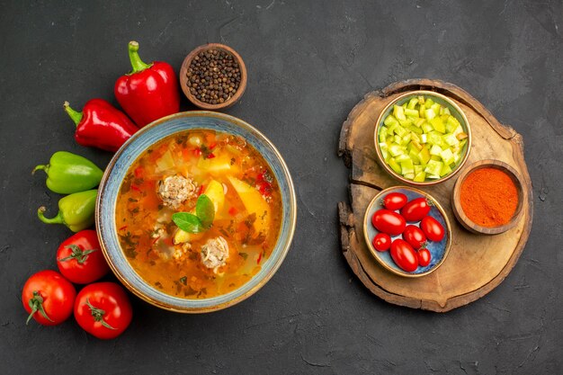 Top view tasty meat soup with fresh vegetables on dark floor photo dish food color