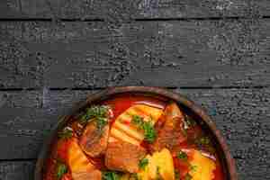 Free photo top view tasty meat soup with potatoes and greens on dark desk