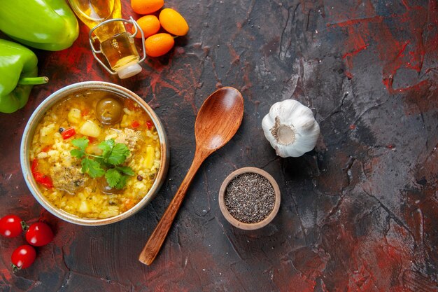 Top view tasty meat soup with potatoes and rice inside little plate on dark surface