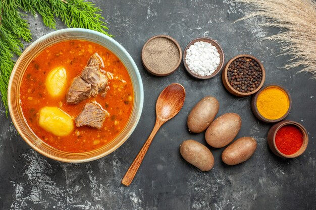 Top view tasty meat soup with potatoes and seasonings