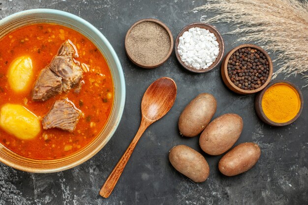 Top view tasty meat soup with potatoes and seasonings