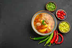 Free photo top view tasty meatballs soup with greens and pepper on dark table sauce dish color