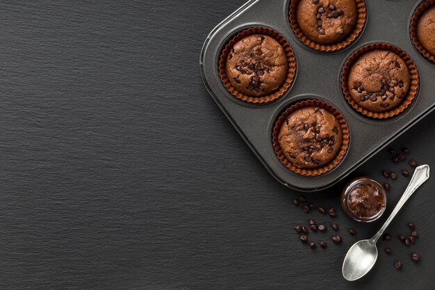 Top view tasty muffin dark copy space background