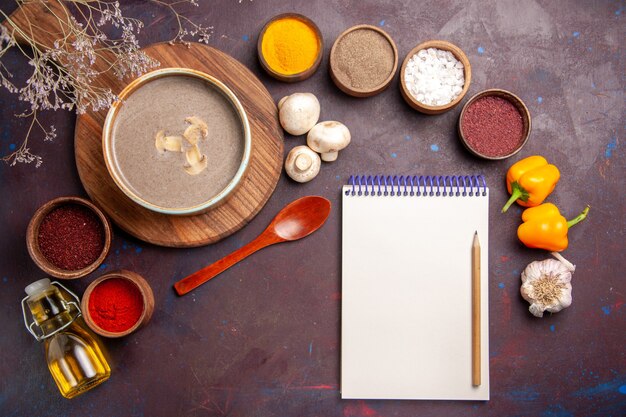 Top view tasty mushroom soup with different seasonings on the dark background soup mushroom seasoning food meal