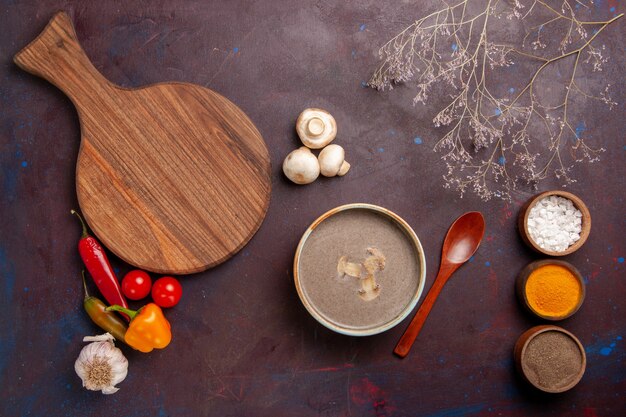 Top view tasty mushroom soup with different seasonings on the dark background soup mushroom seasoning meal