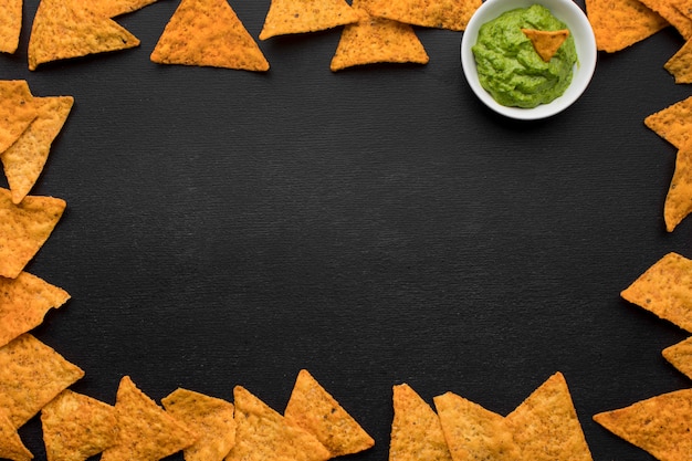 Free photo top view tasty nachos with guacamole on the table