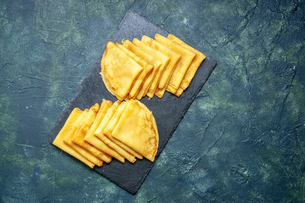 Top view tasty pancakes on blue background sweet breakfast pie dough bake color meat pastry cake