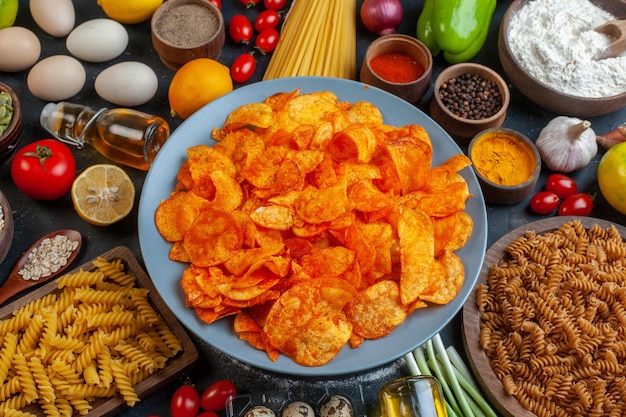 Top view tasty pepper cips with different seasonings and ingredients on a dark background color food meal photo pasta