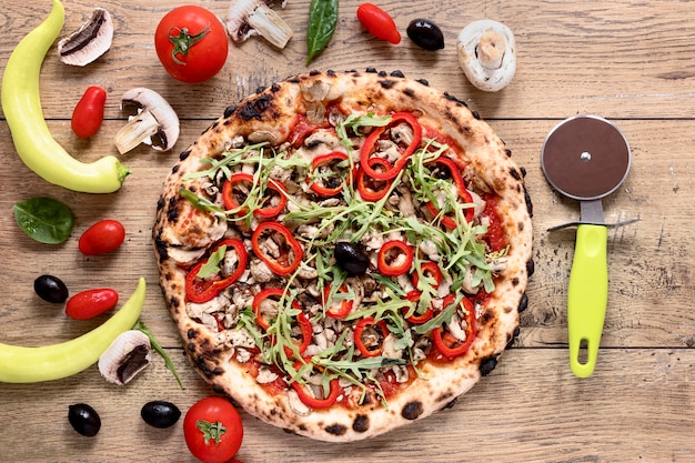 Top view tasty pizza on wooden background