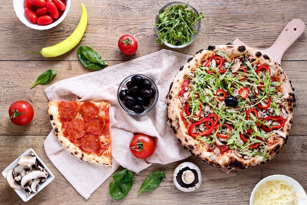 Top view tasty pizza on wooden background