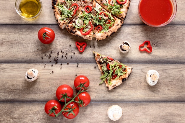 Top view tasty pizza on wooden background