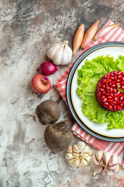 Top view tasty pomegranate salad on green salad with fresh vegetables on the light background