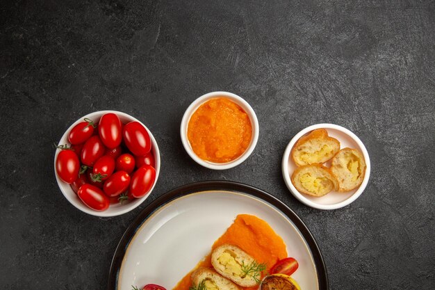 Top view tasty potato pies with pumpkin and fresh tomatoes on grey background bake oven color dish ripe dinner