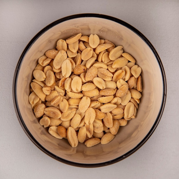 Top view of tasty roasted salty pine nuts on a bowl