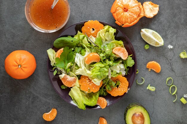 Top view tasty salad with tangerine