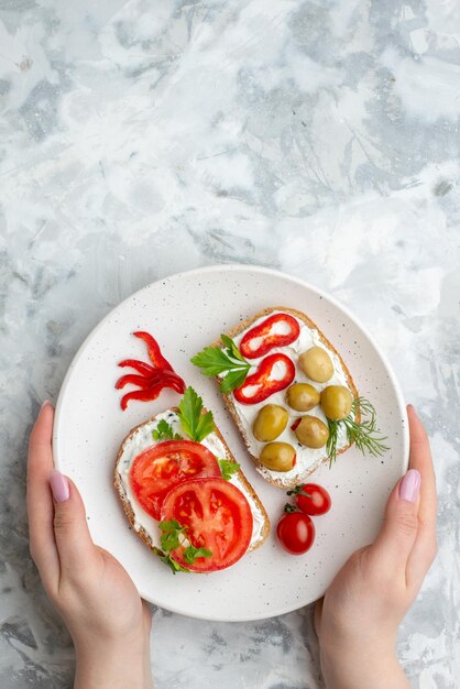 Top view tasty sandwiches with tomatoes and olives on white background food health meal bread lunch horizontal toast burgers