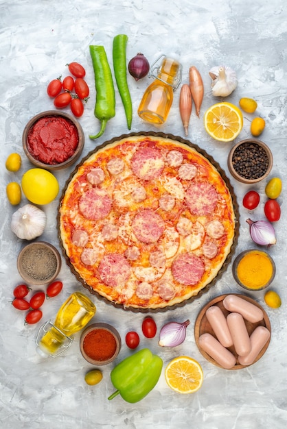 Top view tasty sausage pizza with fresh vegetables on white table oven color dough pie cake bake pizza italy fast-food